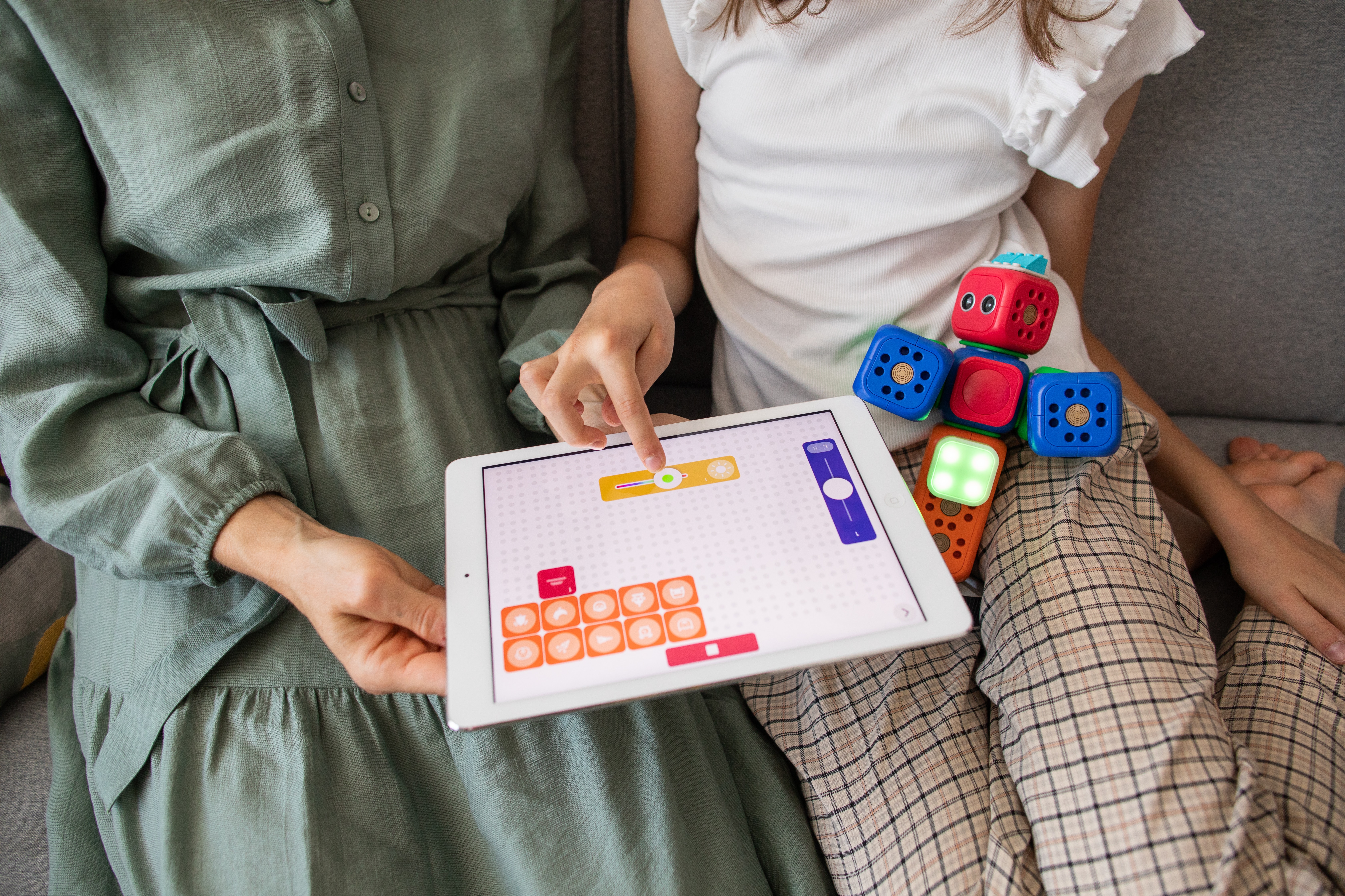 An adult and a child playing a block game in their laps.